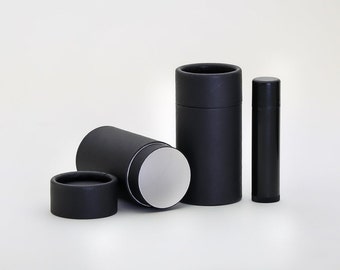 May include: Three black cardboard tubes, one with a white interior, and a black plastic tube. The tubes are for packaging cosmetics or other small items.