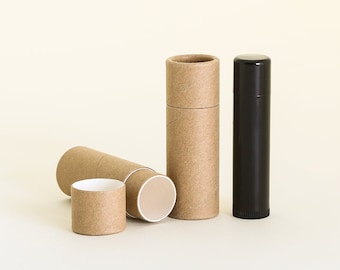 May include: Three cardboard tubes for lip balm or other small items. Two are brown and one is open, showing a white interior. The third tube is black.