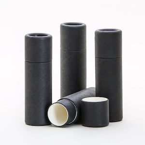 May include: Four black cardboard tubes with a white interior. The tubes are stacked on top of each other, with one tube lying on its side.