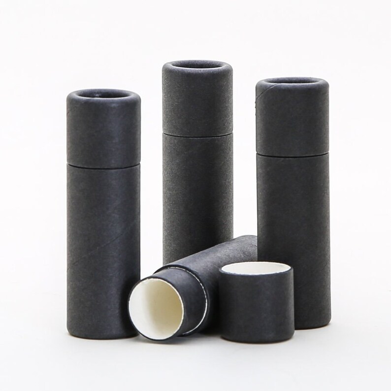 May include: Four black cardboard tubes with a white interior. The tubes are stacked on top of each other, with one tube lying on its side.