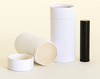 May include: Three white cardboard tubes for packaging deodorant or lip balm. One tube is open, showing the inside. A black tube of lip balm is also shown.
