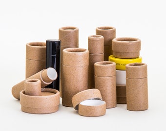 May include: A group of brown cardboard tubes of various sizes, some with lids, and a black tube with a white lid. The tubes are arranged on a white surface.