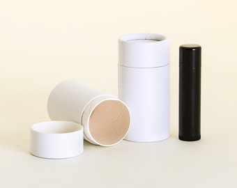 May include: Three white cardboard tubes, one with a brown interior, and a black tube with a rounded top. The tubes are on a light yellow background.