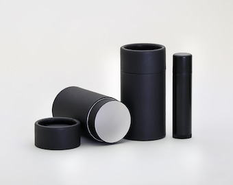 May include: Three black cardboard tubes, one open to reveal a white interior, and a smaller black tube. The tubes are for packaging cosmetics or other products.