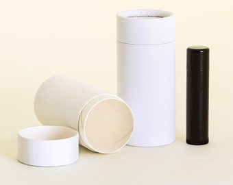 May include: Three white cardboard tubes for packaging deodorant or lip balm. The tubes are empty and one is partially open. A black plastic tube of lip balm is also shown.