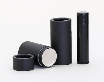 May include: Three black cardboard tubes with a white interior, and one black plastic tube. The tubes are for packaging lip balm or other small items.