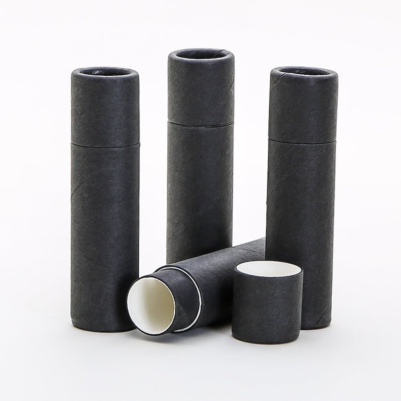 May include: Three black cardboard tubes with white interiors. The tubes are stacked and leaning against each other. The tubes are approximately 1.5 inches in diameter and 3 inches in height.