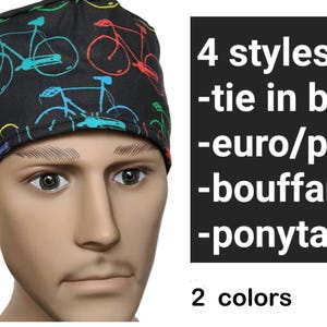 May include: A black scrub hat with a colorful bicycle print. The hat has a tie in the back, euro/pixie, bouffant, and ponytail styles. It is available in two colors.