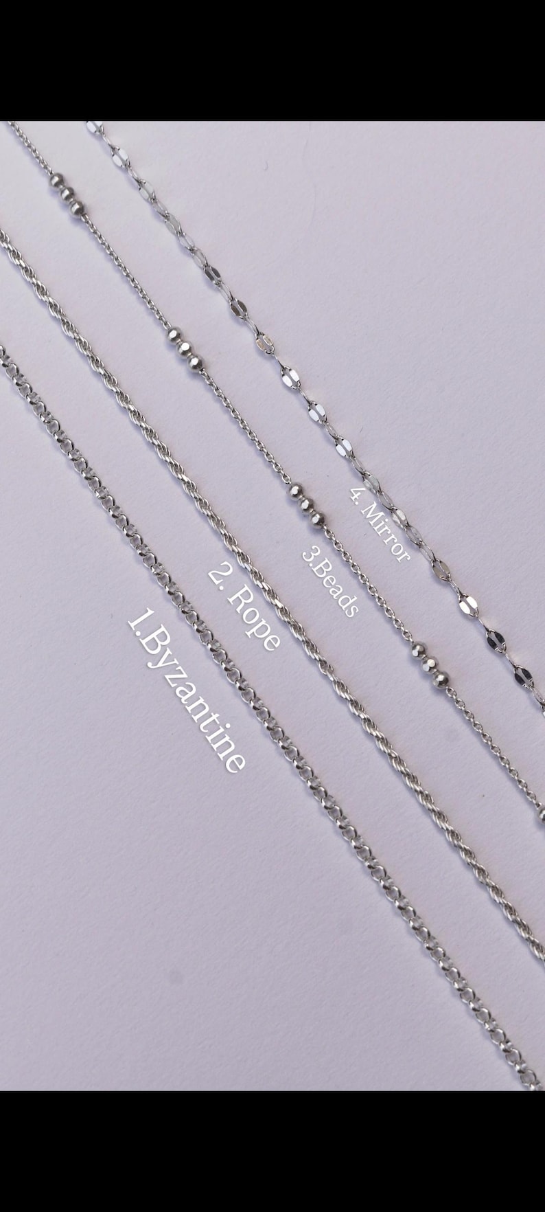 May include: Four silver-toned metal chains arranged diagonally. The chains are labeled as 1. Byzantine, 2. Rope, 3. Beads, and 4. Mirror. Each chain features a distinct link pattern, including a complex woven design, a twisted rope style, a beaded chain, and a flat reflective link style.