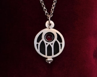 cathedral window locket with garnet
