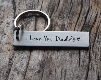 May include: Silver keyring with a rectangular tag that reads "I Love You Daddy" with a heart symbol.