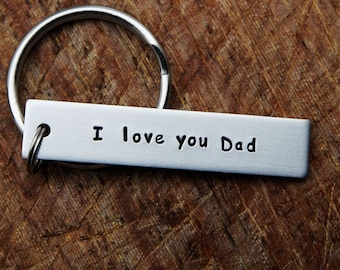 May include: Silver keyring with a rectangular tag that reads "I love you Dad".
