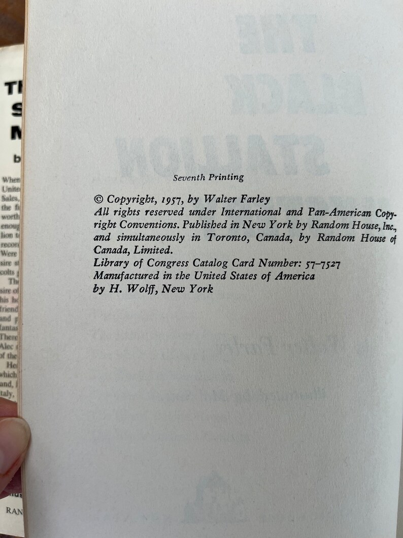 May include: Seventh printing of a book with the title "The Black Stallion" by Walter Farley. Copyright 1957, published by Random House.