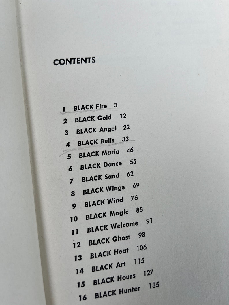 May include: A black and white page with a list of chapter titles and page numbers. The list is titled "CONTENTS". The chapter titles are "BLACK Fire", "BLACK Gold", "BLACK Angel", "BLACK Bulls", "BLACK Mar&iacute;a", "BLACK Dance", "BLACK Sand", "BLACK Wings", "BLACK Wind", "BLACK Magic", "BLACK Welcome", "BLACK Ghost", "BLACK Heat", "BLACK Art", "BLACK Hours", and "BLACK Hunter".