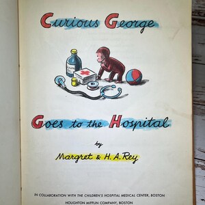 May include: A vintage children's book cover featuring Curious George, a monkey, in a red shirt, going to the hospital. The cover is illustrated with a blue and yellow background and features a red cross first aid kit, a stethoscope, a bottle of medicine, and a blue and red ball.