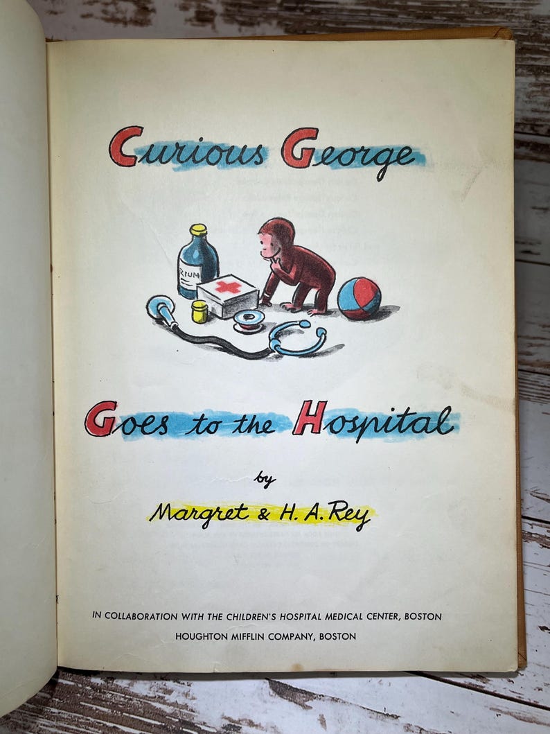 May include: A vintage children's book cover featuring Curious George, a monkey, in a red shirt, going to the hospital. The cover is illustrated with a blue and yellow background and features a red cross first aid kit, a stethoscope, a bottle of medicine, and a blue and red ball.