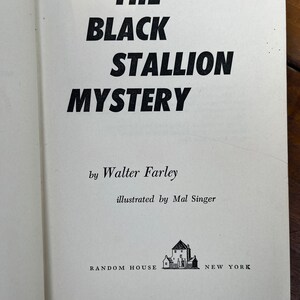 May include: The Black Stallion Mystery book cover by Walter Farley, illustrated by Mal Singer. The cover features a black and white illustration of a house with a chimney and a fence.
