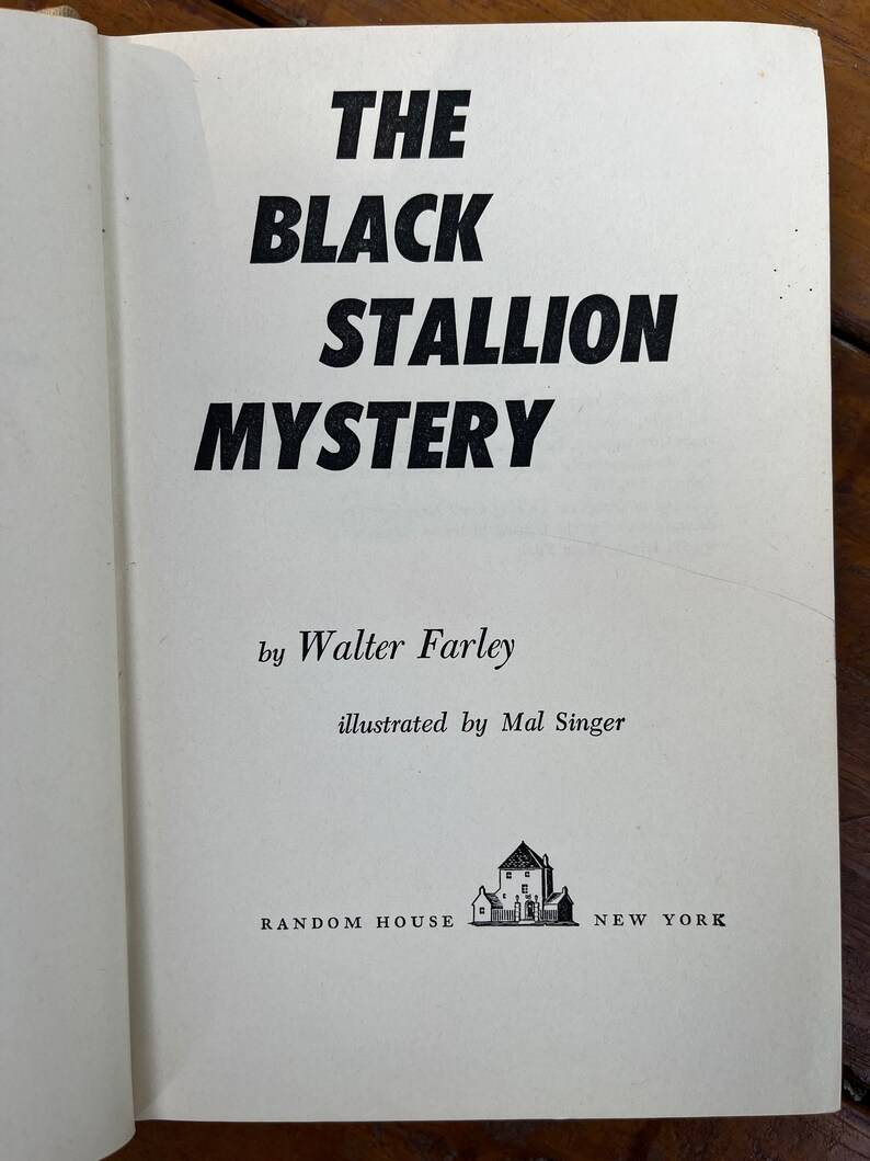 May include: The Black Stallion Mystery book cover by Walter Farley, illustrated by Mal Singer. The cover features a black and white illustration of a house with a chimney and a fence.
