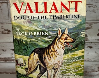 May include: A vintage book cover with a colorful illustration of a German Shepherd dog standing in a field with sheep. The title of the book is "Valiant Dog of the Timberline" by Jack O'Brien. The book is part of the "Famous Dog Stories" series.