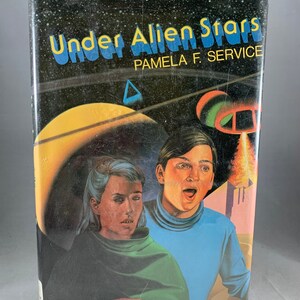May include: A book cover with a black background and a yellow and orange planet in the background. The title of the book is "Under Alien Stars" by Pamela F. Service. The cover features two people, a woman with blonde hair and a man with brown hair, looking up in surprise.