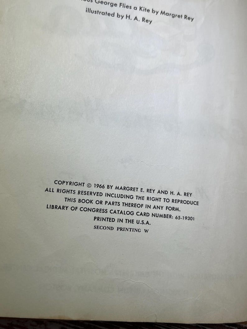 May include: Copyright information for the book "Curious George Flies a Kite" by Margret E. Rey and H. A. Rey. The book was published in 1966 and printed in the U.S.A.