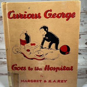 May include: A vintage children's book cover featuring Curious George, a monkey, in a red and black outfit, going to the hospital. The book title is "Curious George Goes to the Hospital" by Margret & H.A. Rey.