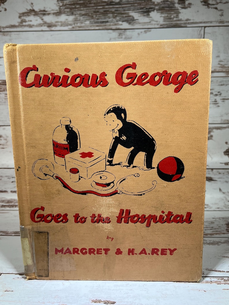 May include: A vintage children's book cover featuring Curious George, a monkey, in a red and black outfit, going to the hospital. The book title is "Curious George Goes to the Hospital" by Margret & H.A. Rey.