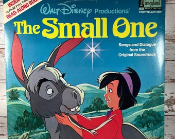 May include: A vintage Walt Disney Productions record album cover featuring a donkey and a young girl. The album is titled "The Small One" and includes songs and dialogue from the original soundtrack. The cover is blue with a yellow star and a white border.