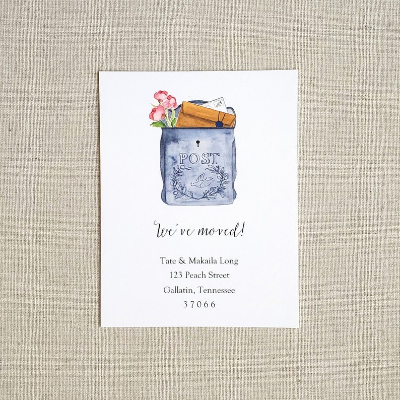 May include: A watercolor illustration of a blue mailbox with the word "POST" on it. The mailbox is overflowing with letters and envelopes. The text "We've moved!" is written below the mailbox, followed by a new address: Tate & Makaila Long, 123 Peach Street, Gallatin, Tennessee 37066.