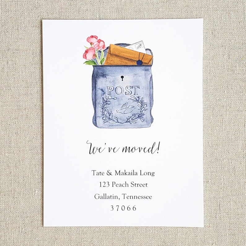 May include: A blue and white mailbox with a floral arrangement and the word "POST" on the front. The text "We've moved!" is written below the mailbox, followed by a new address: Tate & Makaila Long, 123 Peach Street, Gallatin, Tennessee 37066.
