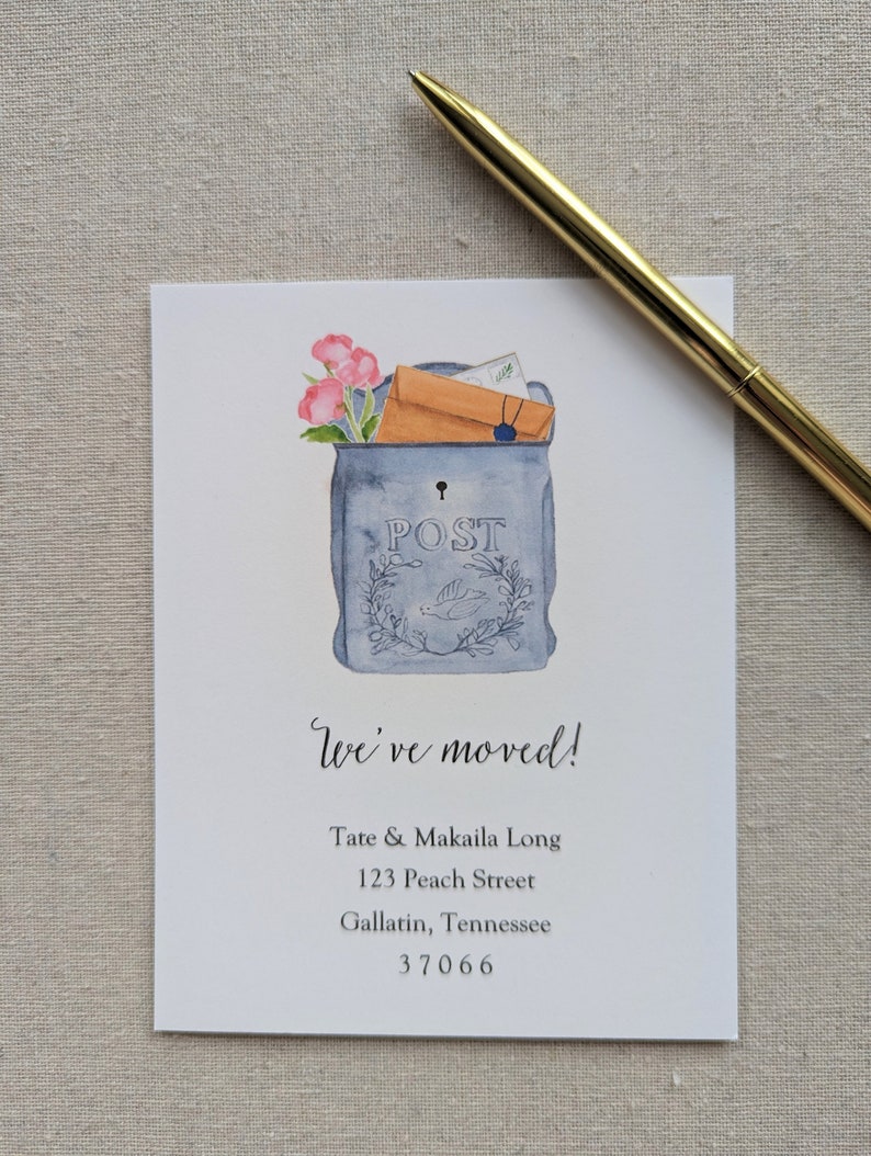 May include: A watercolor illustration of a blue mailbox with a white bird and flowers. The mailbox has the word "POST" on it. The text "We've moved!" is written below the mailbox, followed by the address "Tate & Makaila Long, 123 Peach Street, Gallatin, Tennessee 37066".