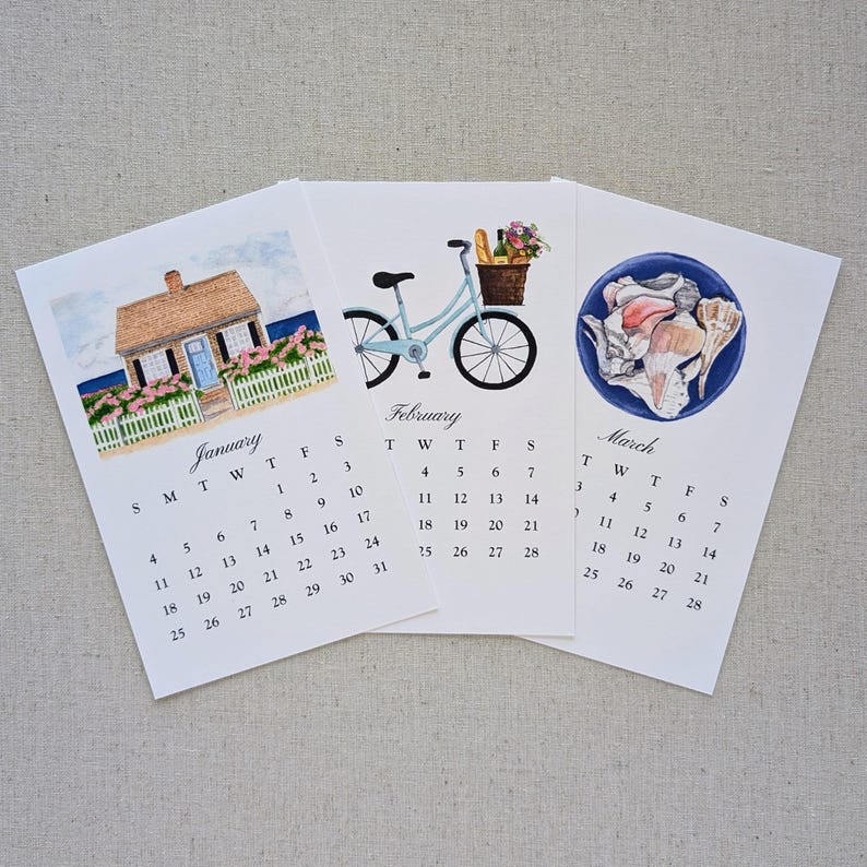 May include: Three watercolor art prints of monthly calendars. January shows a house, February a bicycle with a basket, and March seashells. Each calendar has a white background with the month's name and dates.