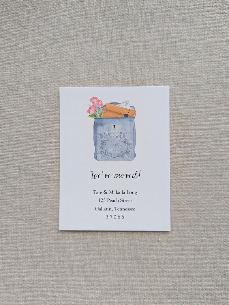 May include: A watercolor illustration of a blue mailbox with a white "POST" sign. The mailbox is overflowing with envelopes and flowers. The text "We've moved!" is written in cursive below the mailbox, followed by the new address: Tate & Makaila Long, 123 Peach Street, Gallatin, Tennessee 37066.