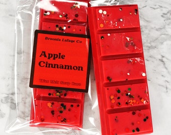 May include: Two red wax melt snap bars with a red, white, and brown label that reads "Breonia Lafaye Co. Apple Cinnamon Wax Melt Snap Bars".