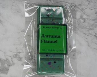May include: A green wax melt snap bar with glitter and the text "Breonia Lafayette Co. Autumn Flannel Wax Melt Snap Bars" on the label.