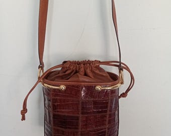 Rare vintage 1990's luxurious handmade eel skin and leather bucket bag with a drawstring closure