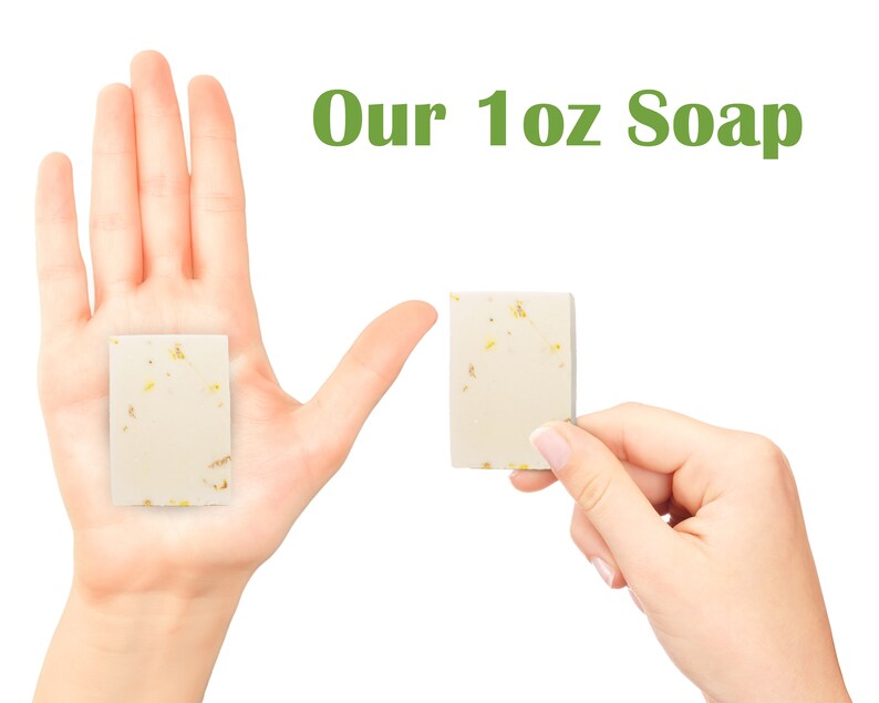 Pu&ograve; includere: Due mani che tengono una saponetta da 1 oncia. Il sapone &egrave; bianco con macchie dorate. Il testo "Our 1 oz Soap" &egrave; scritto in verde sopra le mani.