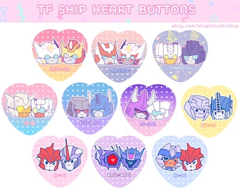 May include: Nine heart-shaped buttons featuring pairs of cartoon Transformers characters. Each button has a different pair of characters, including Drift and Rod, Ratchet and  Wheeljack,  and  Megatron and Starscream. The buttons are pink, blue, and yellow.