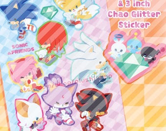 May include: A sticker sheet featuring Sonic the Hedgehog characters including Tails, Knuckles, Amy, Silver, Blaze, Rouge, and Shadow, plus a separate 3-inch Chao glitter sticker. The text reads Sticker Sheet & 3 inch Chao Glitter Sticker, Sonic & Friends.