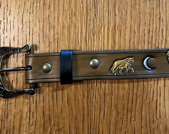 Brown leather belt; wolves and moon, with bronze hardware.