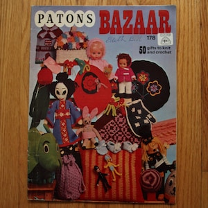 May include: A vintage Patons Bazaar knitting and crochet pattern book with a cover featuring a colourful array of knitted toys, including a doll, a bunny, and a gnome. The book is titled "Patons Bazaar" and features the text "50 gifts to knit and crochet".
