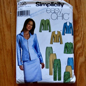 May include: A Simplicity 9700 sewing pattern envelope for an easy chic jacket and skirt or trousers set. The white paper envelope features illustrations of various jacket and bottom combinations in blue, green, and tan colours, with a barcode at the top.