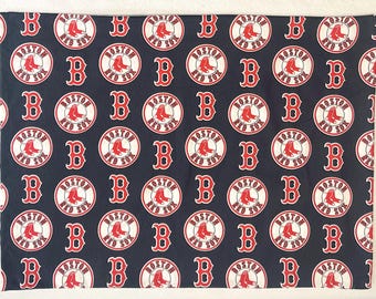May include: A navy blue fabric featuring a repeating pattern of the Boston Red Sox logo and the letter "B" in red and white. The logo includes a red sock inside a white circle with the words "BOSTON RED SOX".