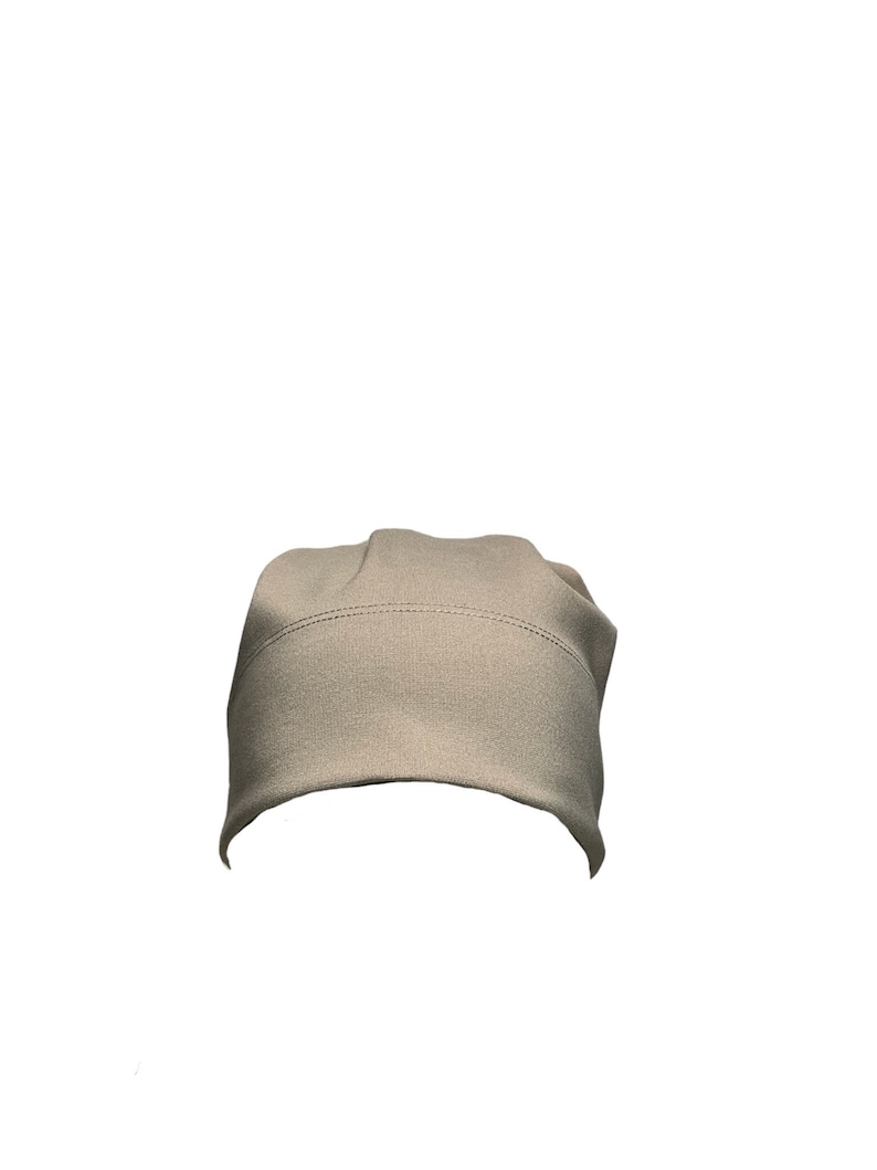 May include: A plain, light beige beanie hat.