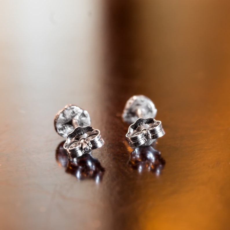 the backside of the post earrings. Each set arrives with pushbacks to keep your earrings securely in place