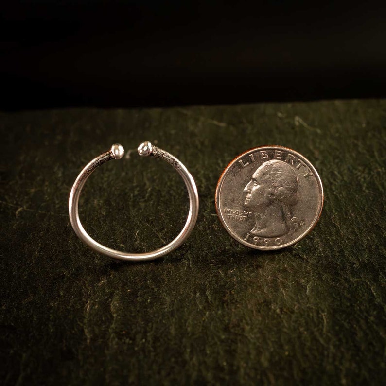 These ear cuffs are slightly larger than the size of a US quarter