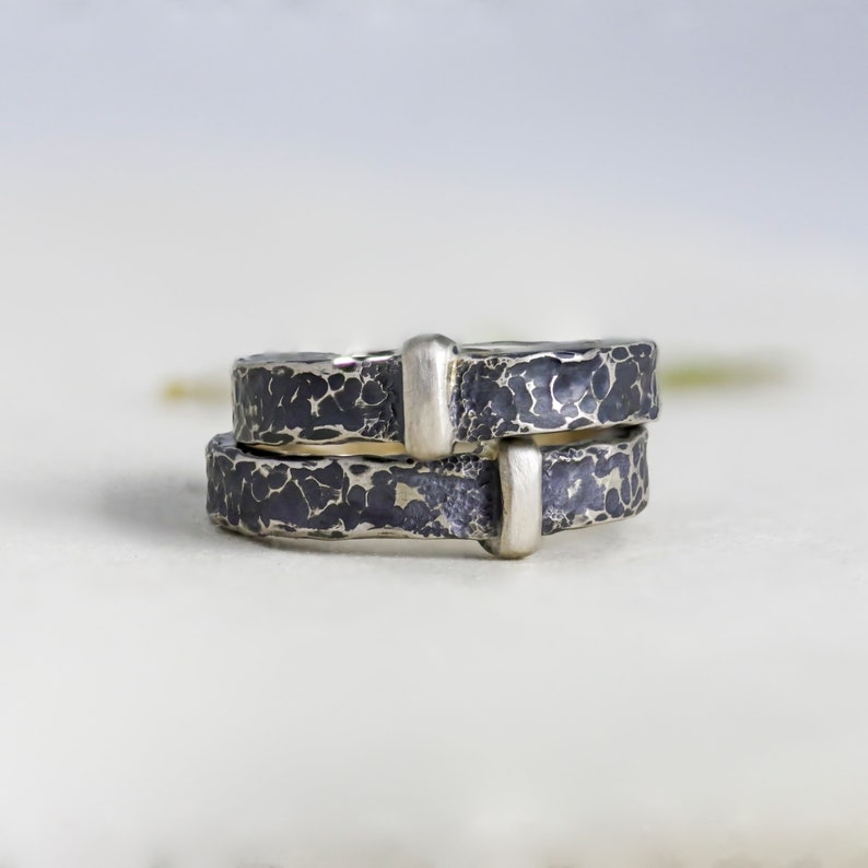 2 outlander-inspired claires rings stacked on top of each other. The photo is taken at close range to show the hammered details. Unisex styling