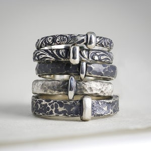 A stack of 5 popular Outlander inspired sterling silver ring styles handmade by Skolland Jewelry