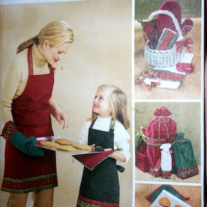 May include: A Butterick pattern cover featuring a woman and child wearing aprons, holding cookies. The aprons are red and green with decorative trim. Additional images show oven mitts, a basket, and gift bags.