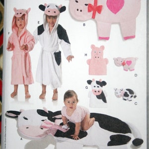 May include: A sewing pattern for a cow and pig themed baby blanket, hooded towel, and hand puppet. The pattern includes a cow-shaped blanket, a cow-shaped hooded towel, a pig-shaped hooded towel, a pig-shaped hand puppet, and a small cow and pig plush toy.
